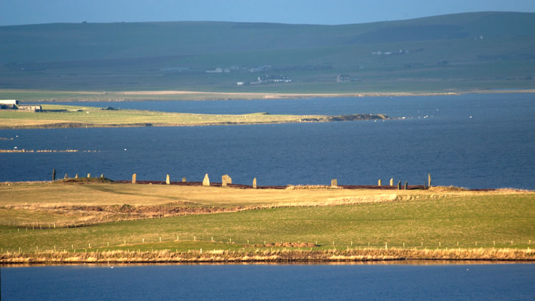 The Ring of Brodgar across the lochs