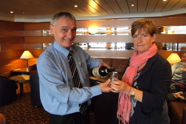 Tommy offers passengers a taste of St Magnus whisky by Highland Park on MV Hamnavoe