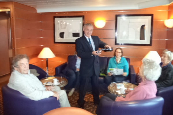 Tommy offers passengers a taste of St Magnus whisky by Highland Park on MV Hamnavoe