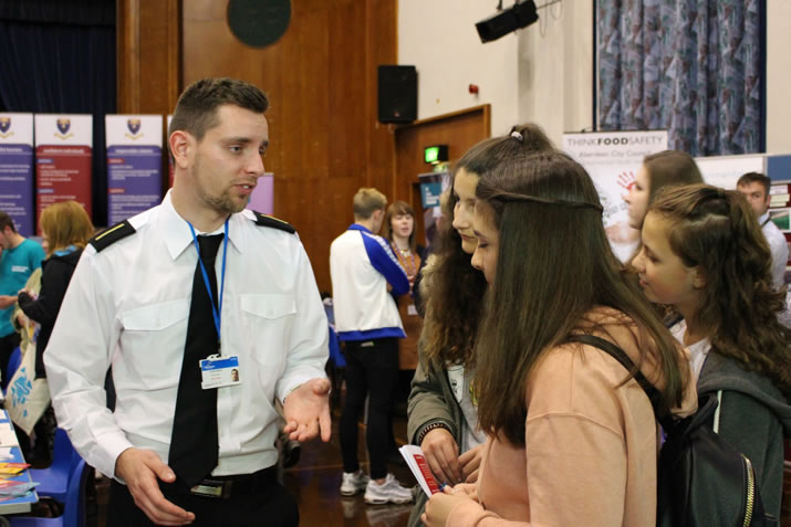 Cadet Oli Bates discusses careers at NorthLink Ferries with pupils