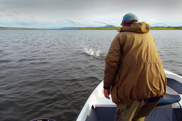 Catching a large fish on Harray Loch, Orkney