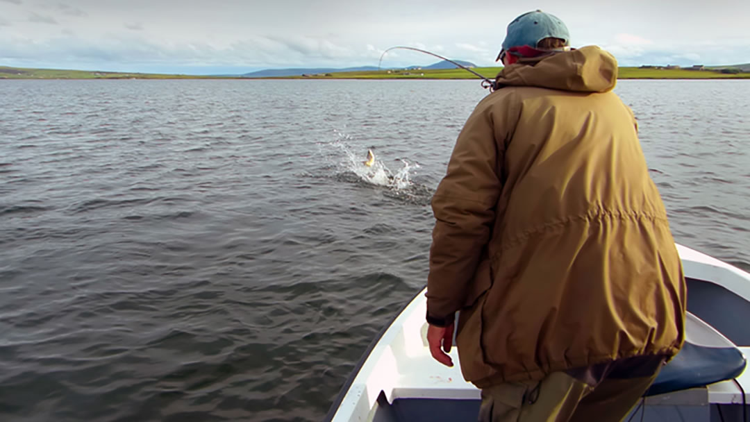 Catching a large fish on Harray Loch, Orkney