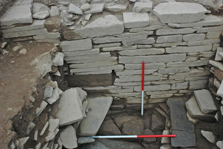 The southern enclosing wall surviving to almost 6ft in height at the Ness of Brodgar, Orkney