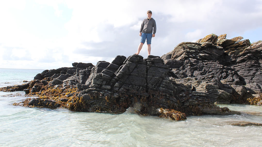Climbing on rocks at Egilsay's beach