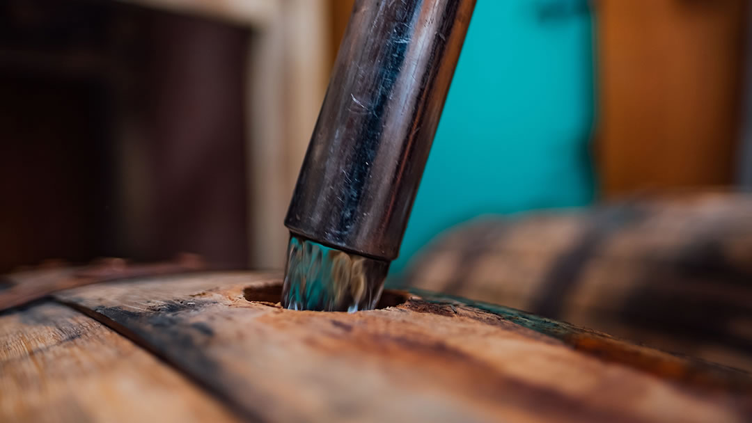 Filling a bourbon cask with J. Gow Scottish rum