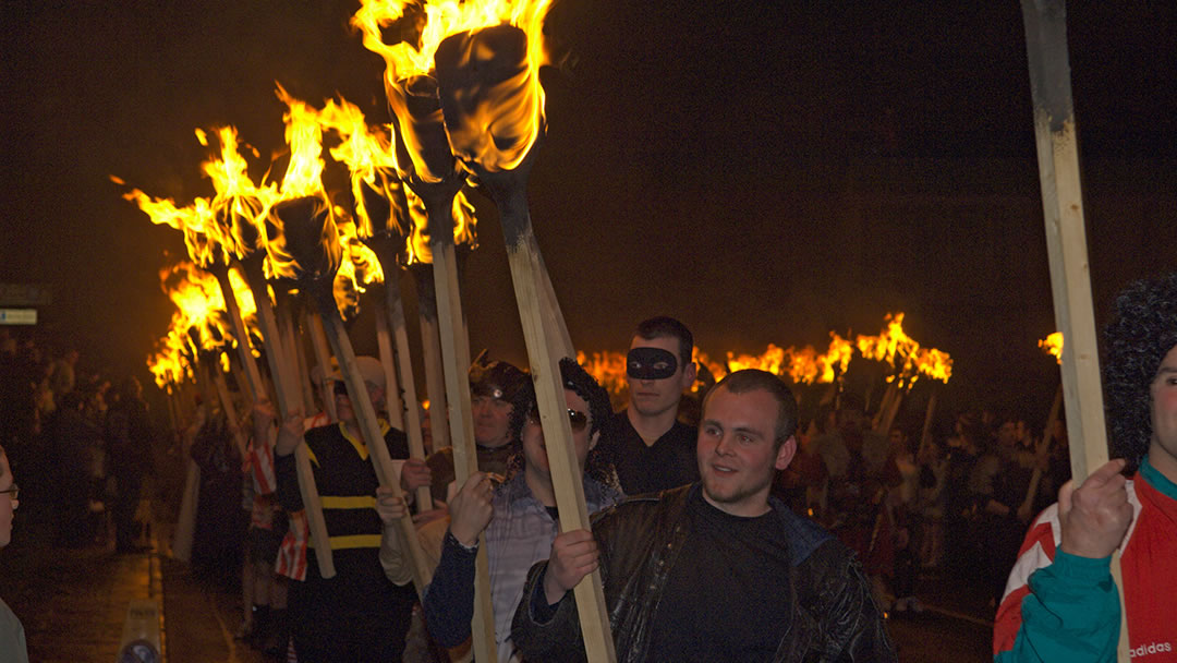Guizers with flaming torches during Up Helly Aa, Shetland