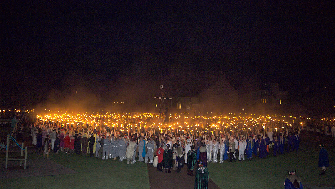 Flaming torches encircle the Viking Longship during Up Helly Aa in Shetland