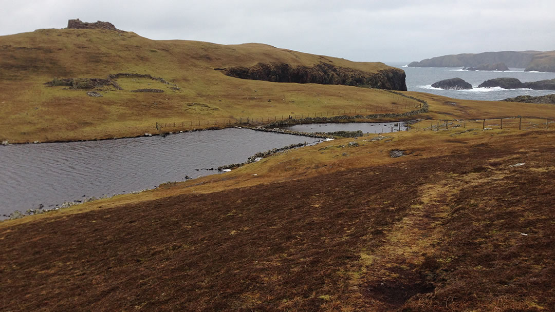 The loch and causeway to Culswick Broch in Shetland