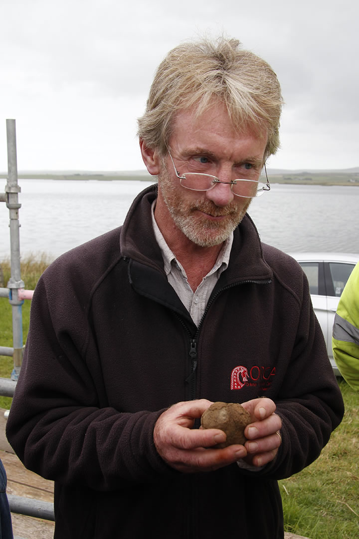 Nick cradles the carved stone ball