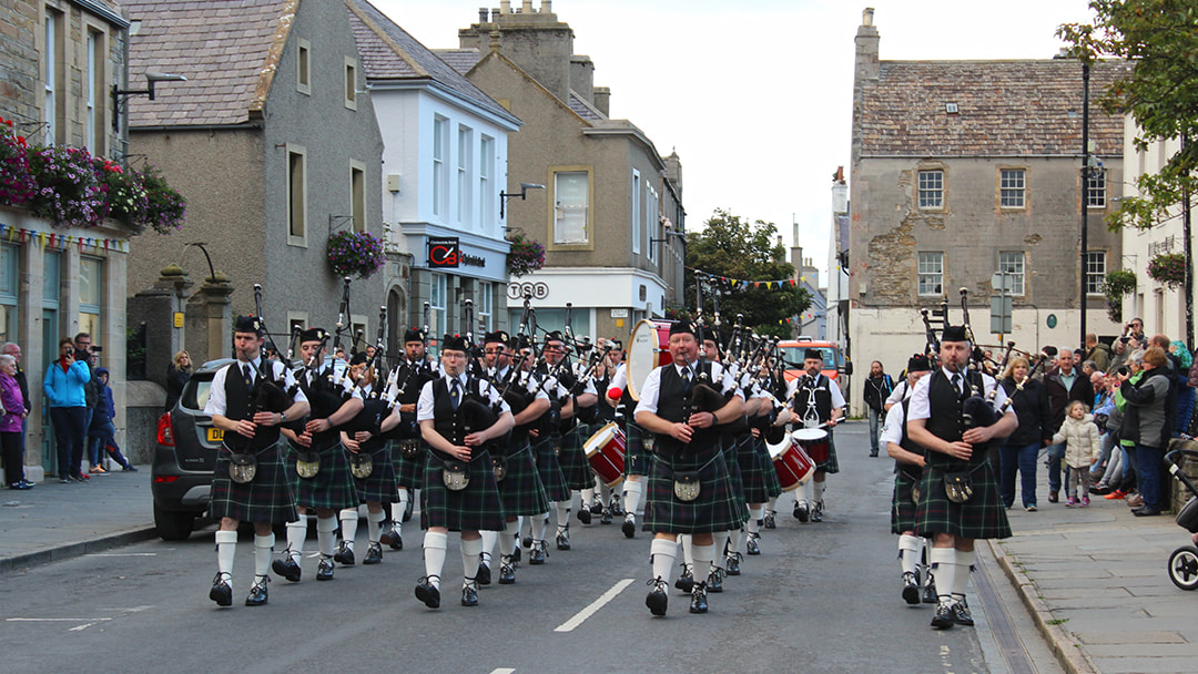 Pipe band playing through the streets of Kirkwall
