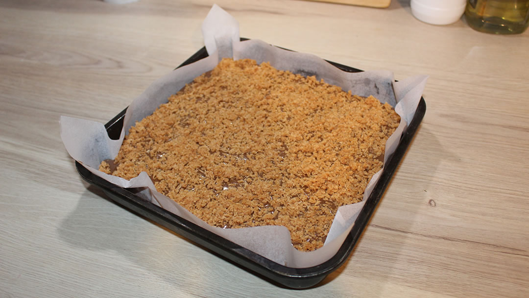 Orkney Fudge Chocolate Brownie in a tray, ready to bake with grated fudge spread on top