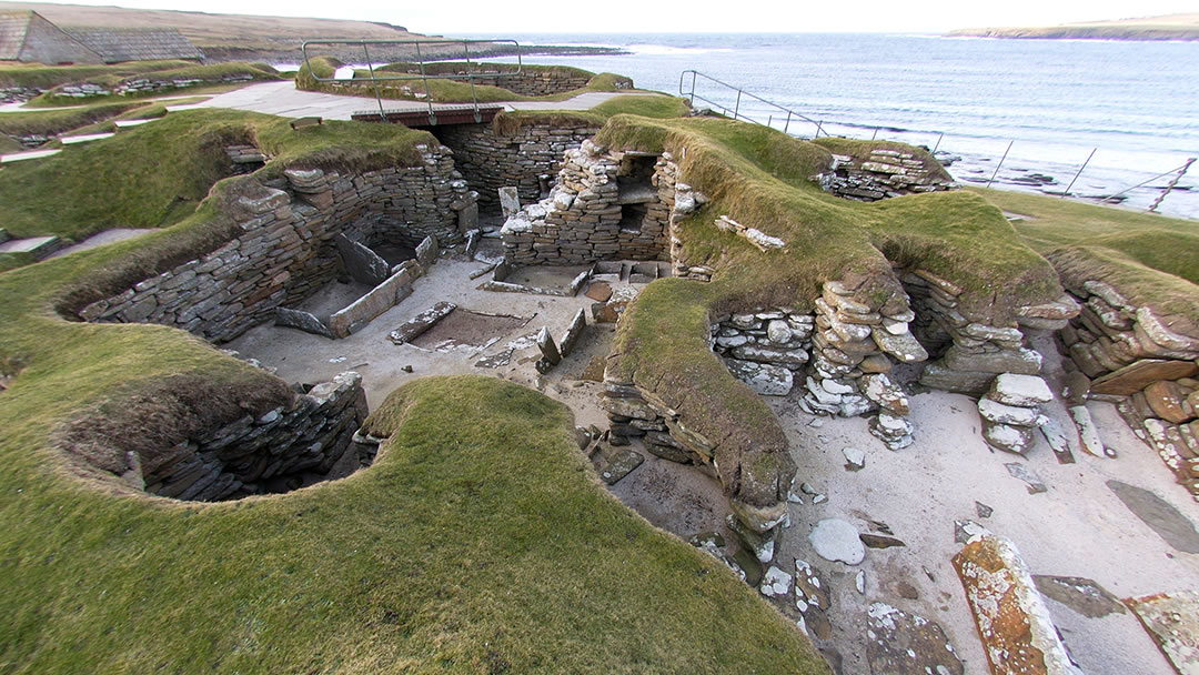 The Neolithic village Skara Brae is an essential stop on a cycling tour of Orkney