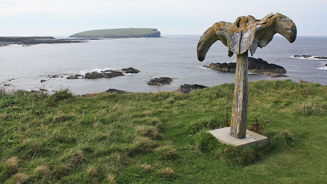 The Birsay whalebone with the Brough of Birsay in the distance