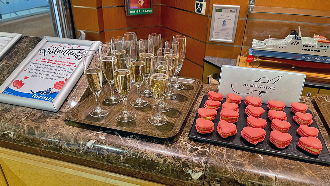 Complimentary glasses of champagne and macarons for Valentine's Day