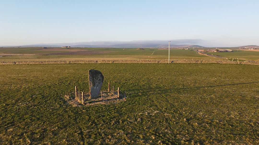The Barnhouse Stone in Orkney, with Maeshowe in the distance