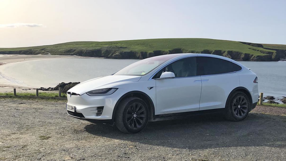 A Tesla Model X at St Ninian's Isle in Shetland