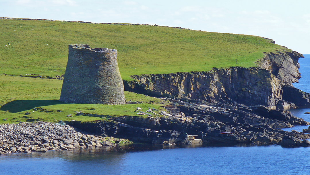 The imposing Mousa Broch on the shoreline