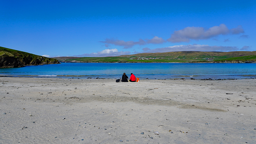 A family enjoying a picnic on the peaceful beach