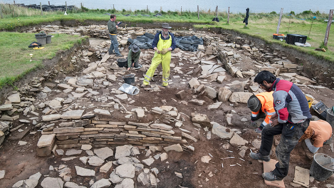 Archaeologists in Trench J excavating Structure 5, the oldest building on site