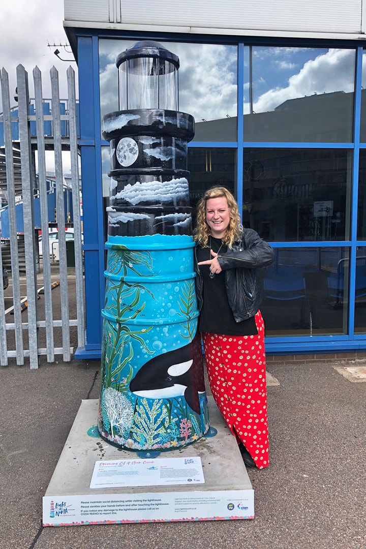 Artist Jodie Bews with the lighthouse she designed at Aberdeen Terminal