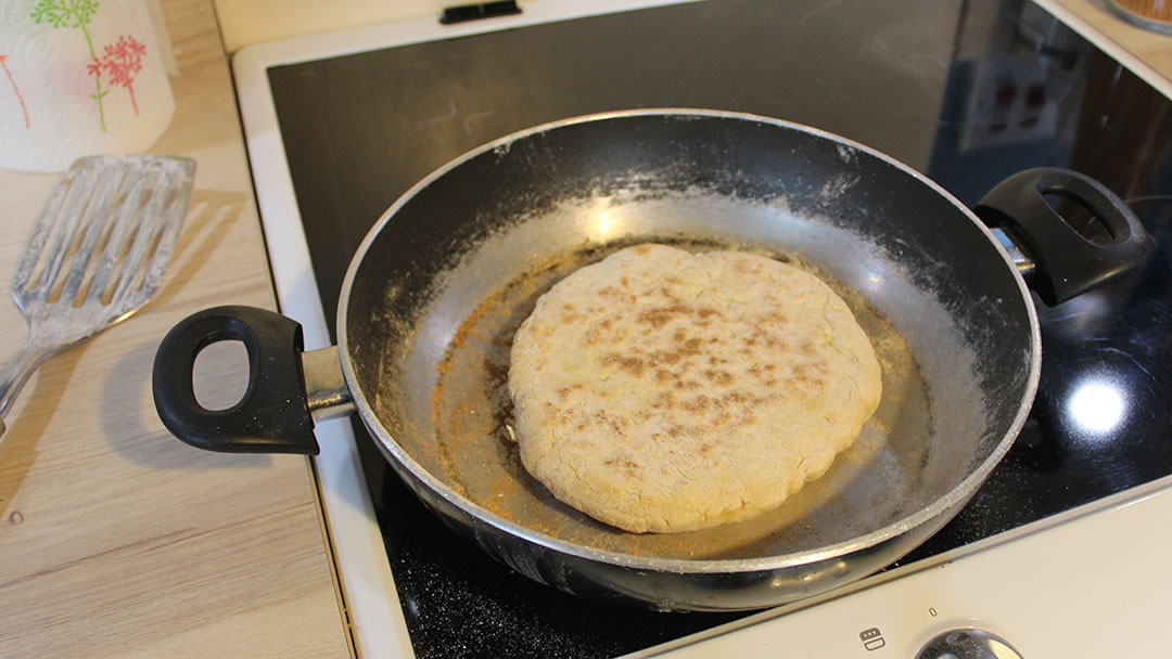 Baking the floorie bannock on a gridle, or in this case, a frying pan