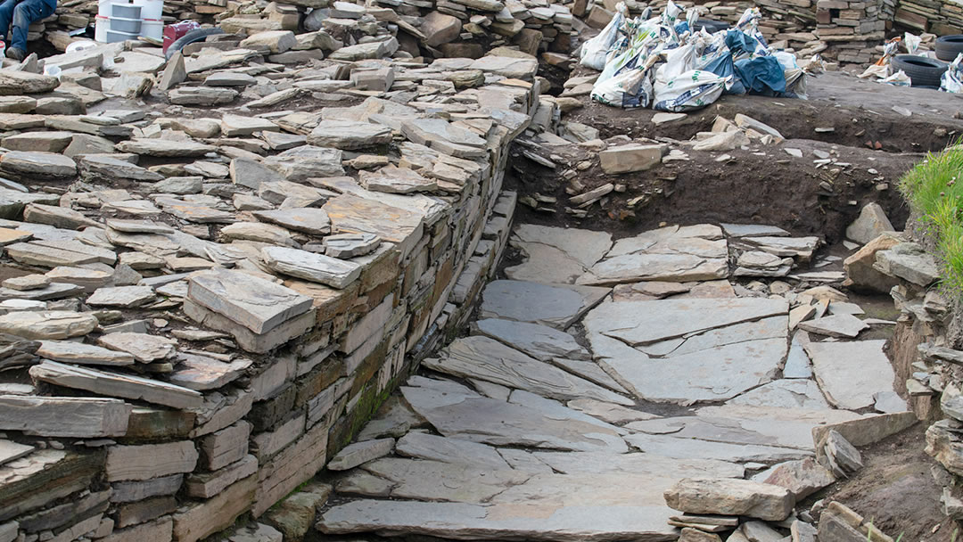 The beautifully constructed wall of Structure 10 with part of its surrounding paved pathway