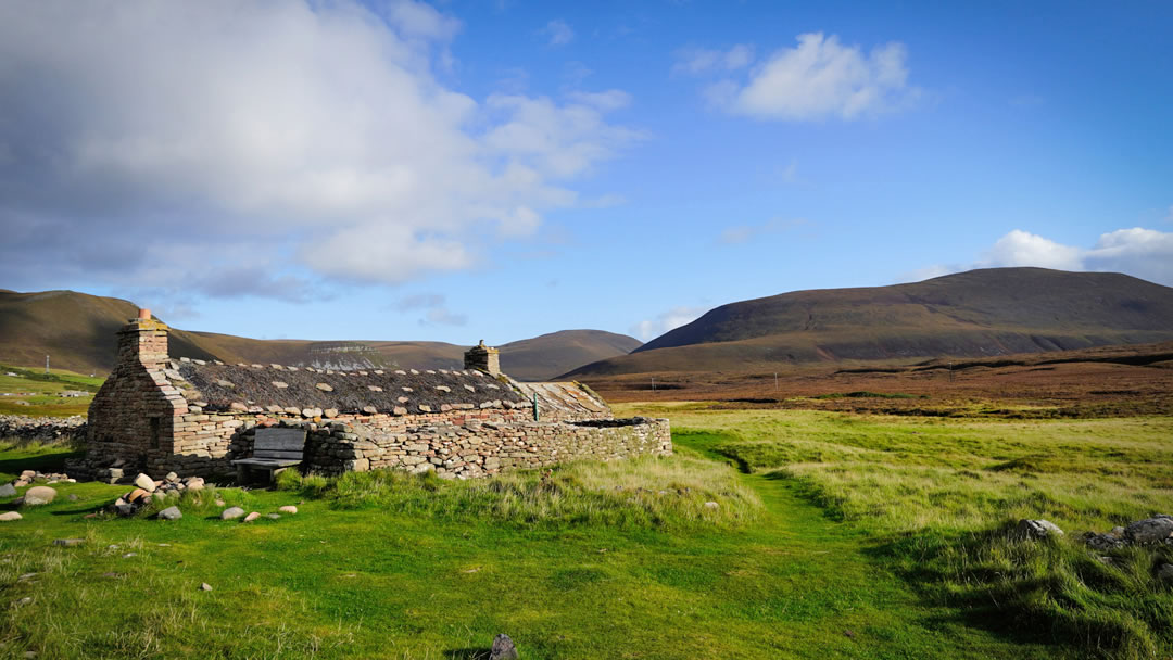 Burnmouth bothy in Hoy, with Ward Hill, Orkney's tallest peak, in the background