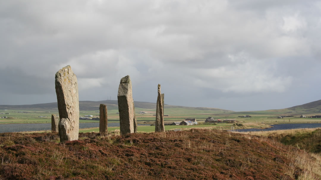 The Ring of Brodgar in autumn, with the Standing Stones of Stenness in the distance.