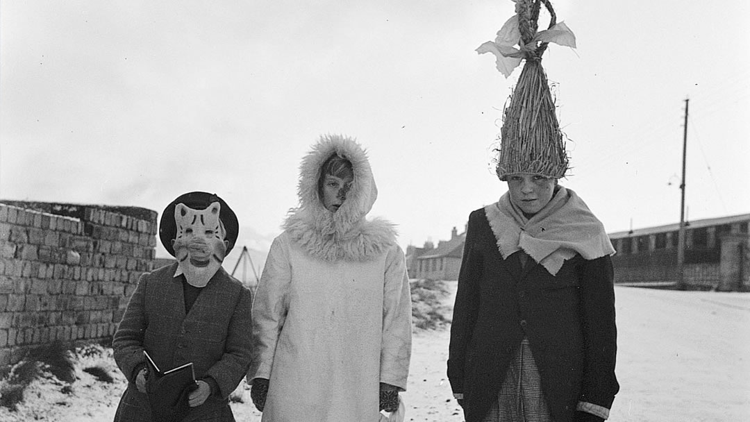 Three young guizers on Twageos road, Lerwick in the 1950s