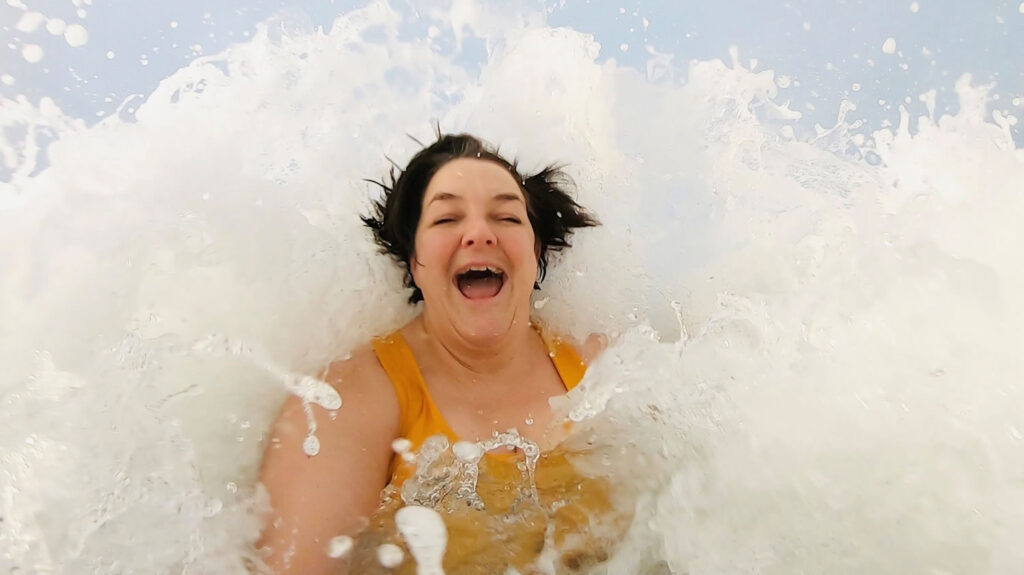 Sarah Kennedy Norquoy in the waves