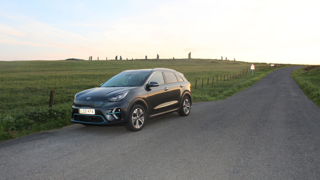Taking an electric vehicles to Orkney - a Kia e-Niro with the Ring of Brodgar in the background