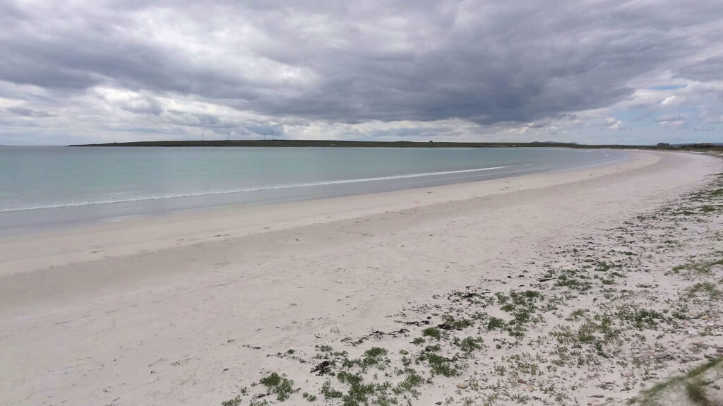 Looking across the beach of the Sand of Rothiesholm to Bay of Holland in Stronsay