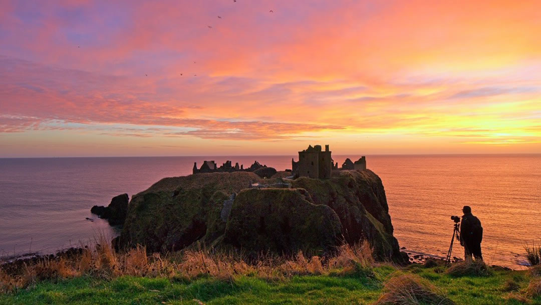 A magnificent sunset at Dunnottar Castle near Stonehaven, Aberdeenshire