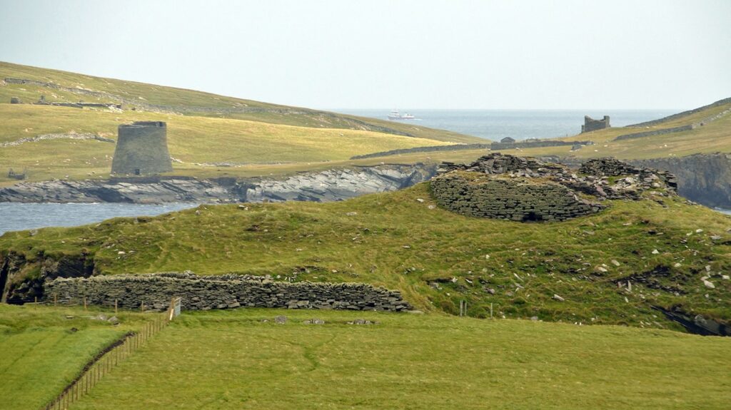 An imposing view of Burraland Broch (right) and Mousa Broch in the distance (left)
