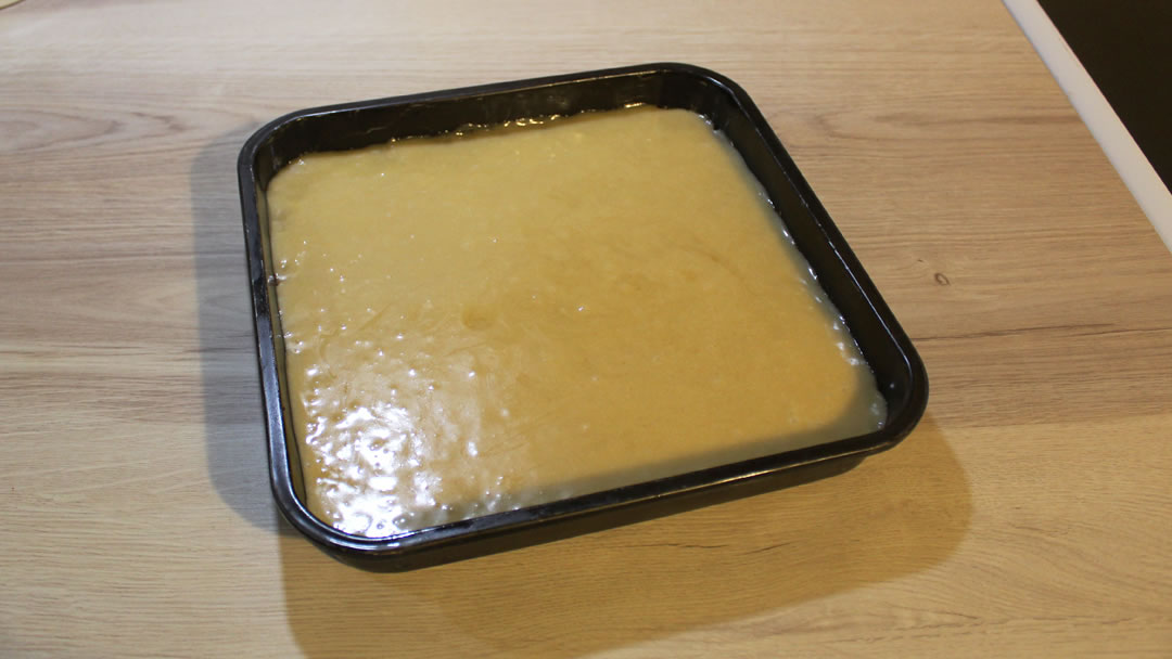 The traybake is left to set after the topping is spread across the top