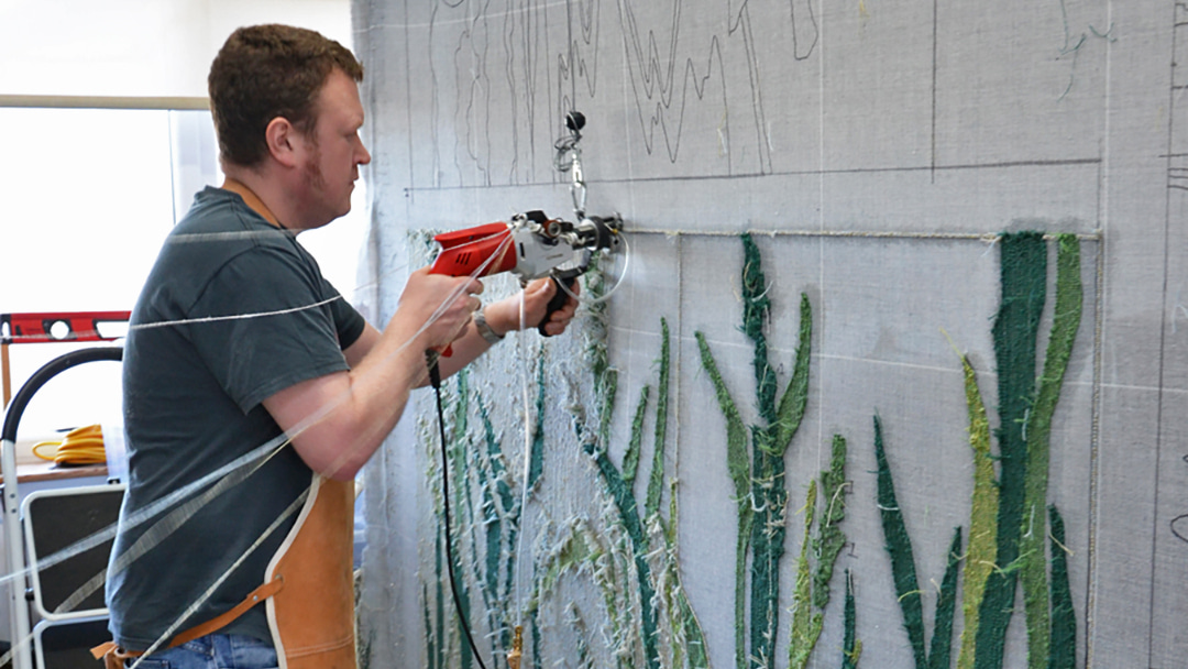 Jo's brother Andrew working on 'Wildgrasses' rug