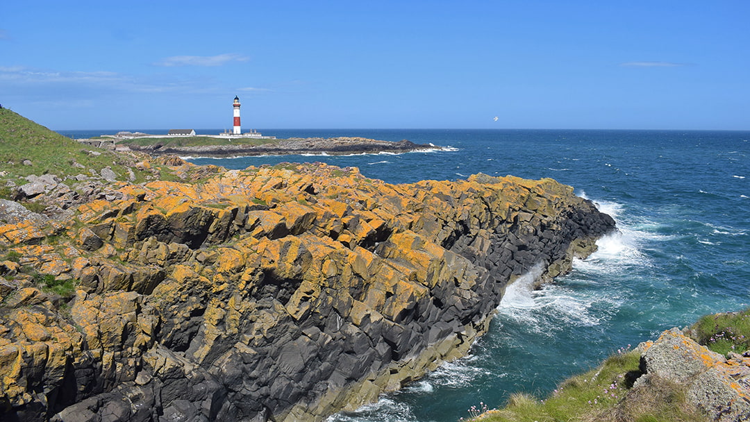 The rugged cliffs surrounding Buchan Ness Lighthouse
