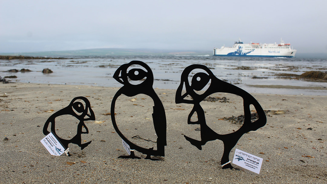 The beautiful metal puffins in front of the MV Hamnavoe