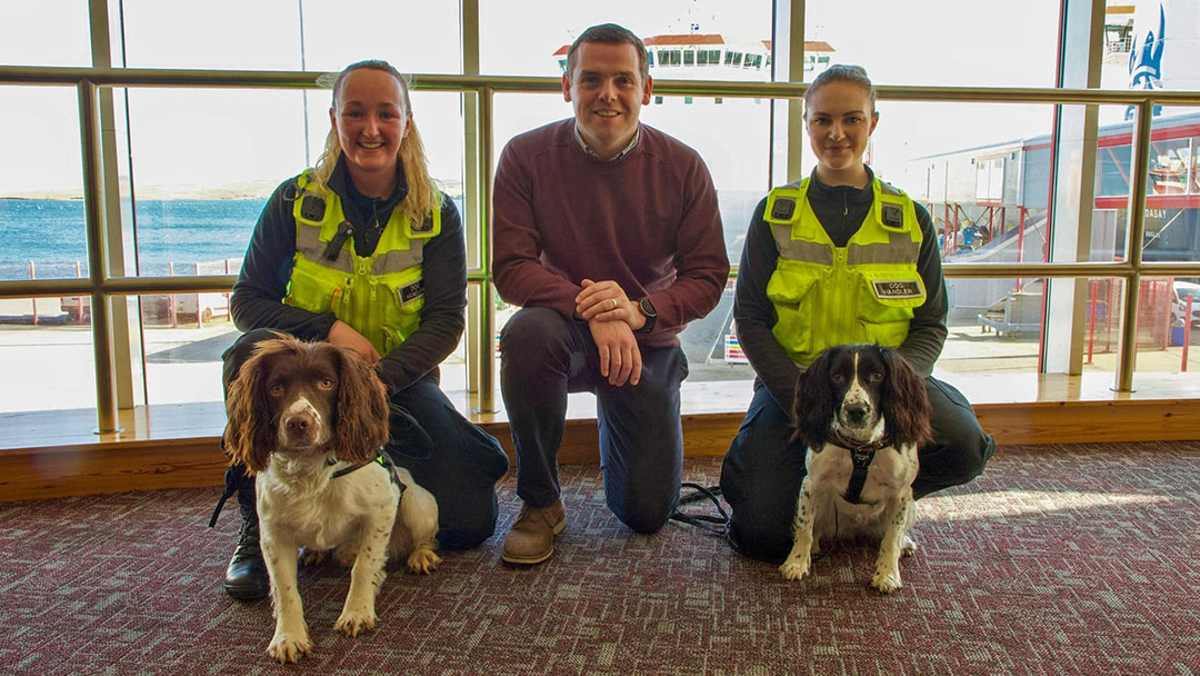 Douglas Ross MP with Handlers with Drugs Dogs, Bravo and Hera, at Holmsgarth Terminal in Lerwick