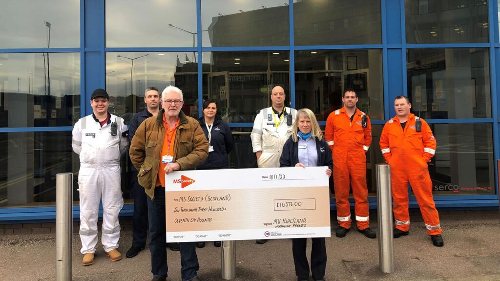 Katheryn Fullerton, Shop Manager and one of the main fundraisers at NorthLink Ferries, hands over a cheque to Mark Colley-Davies, Community Fundraiser at MS Society Scotland, accompanied by NorthLink Ferries colleagues