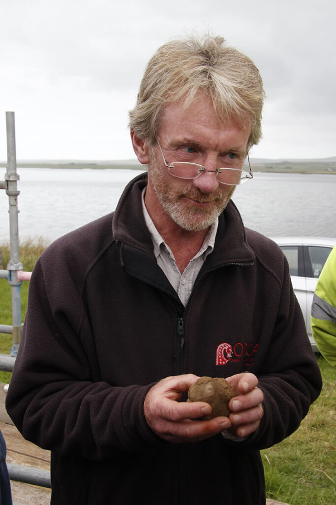 Nick cradles the carved stone ball