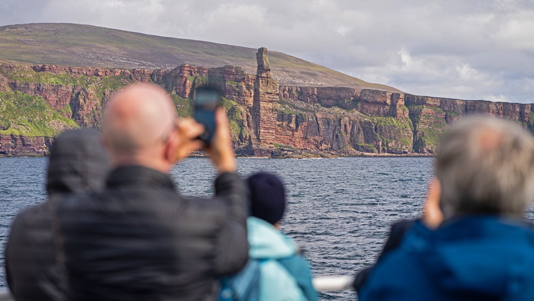 Passengers photographing the Old Man of Hoy onboard the MV Hamnavoe