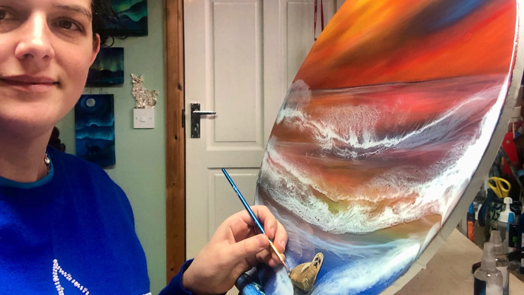 Sarah Kay working on a piece of art in her studio