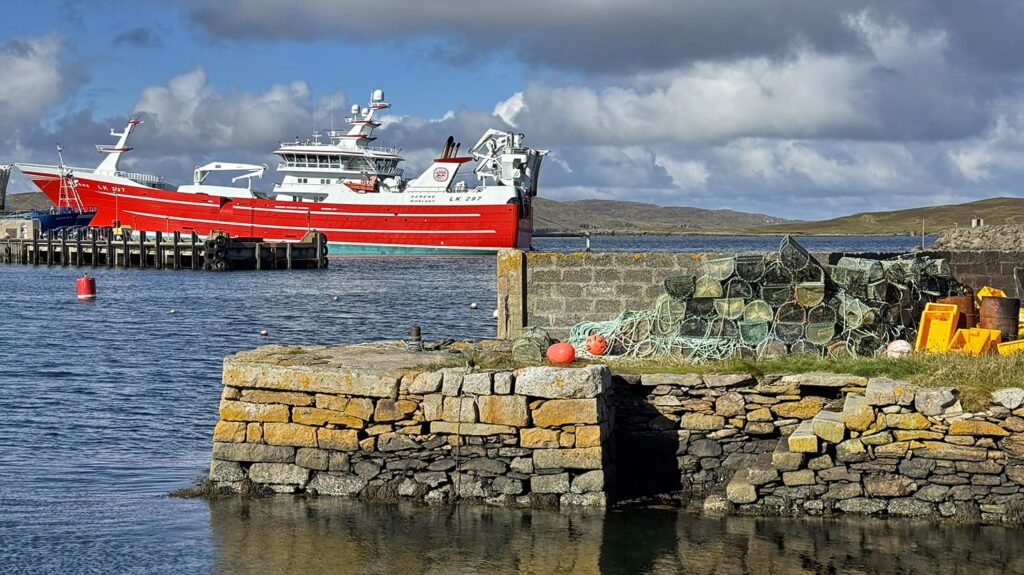 A large pelagic trawler berthed at Whalsay harbour