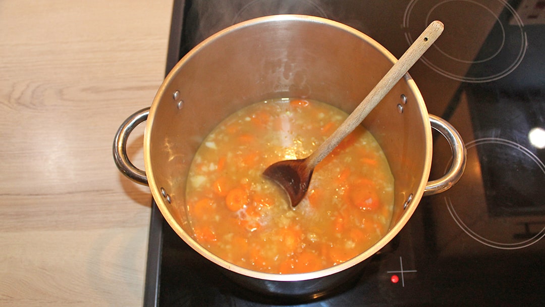 Add carrots and vegetable stock before bringing to a boil
