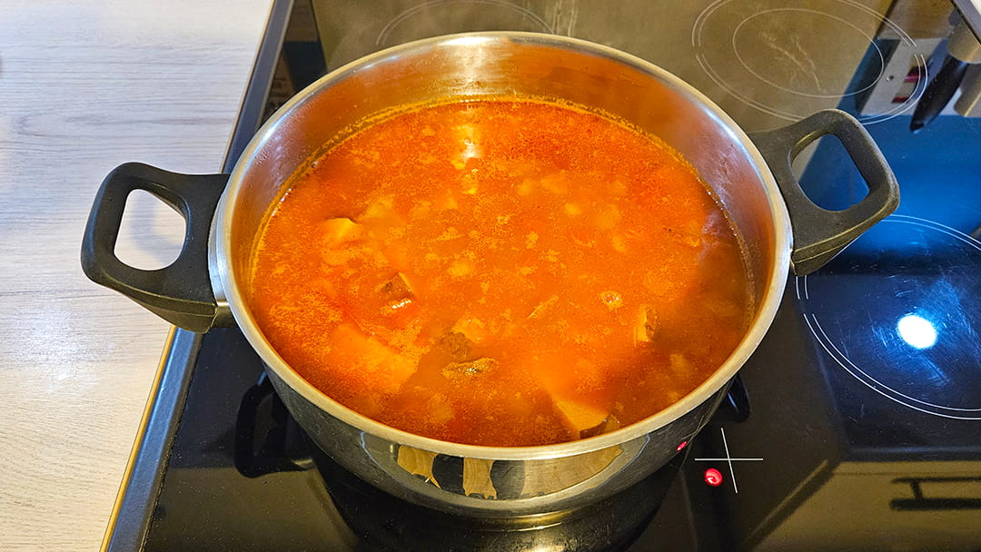 Add chopped tomatoes, vegetable stock, rinsed red lentils and roasted sweet potato to saucepan