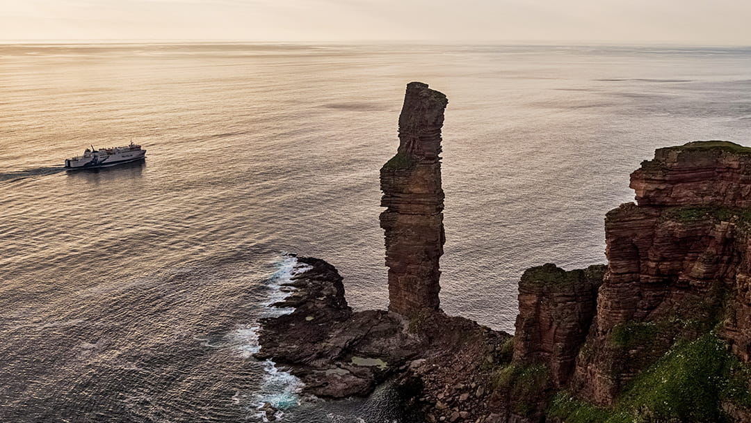 The MV Hamnavoe sailing past the Old Man of Hoy