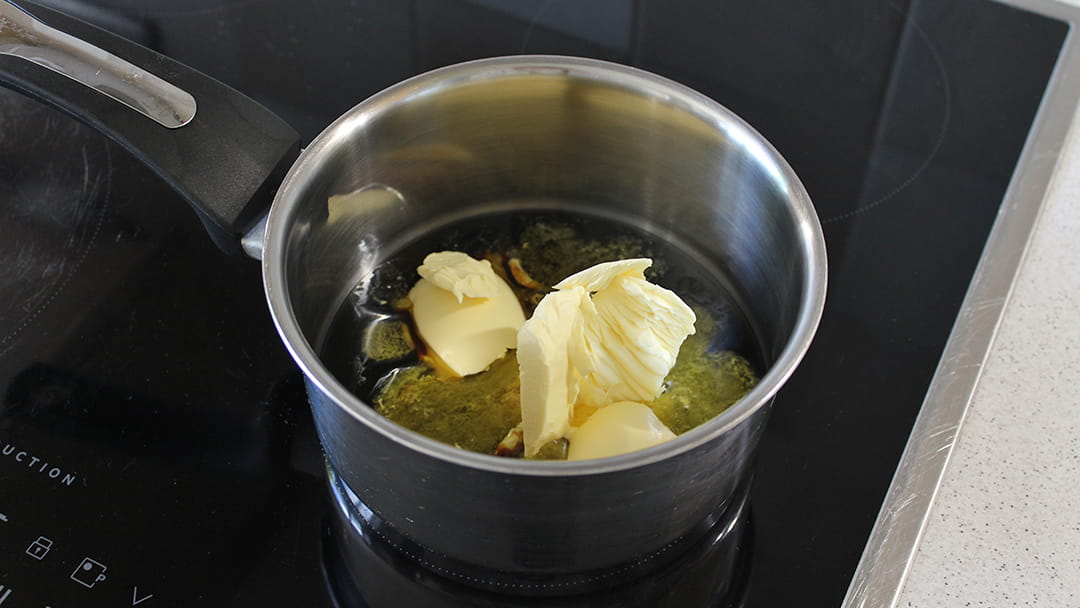 Melt the treacle, golden syrup and margarine together
