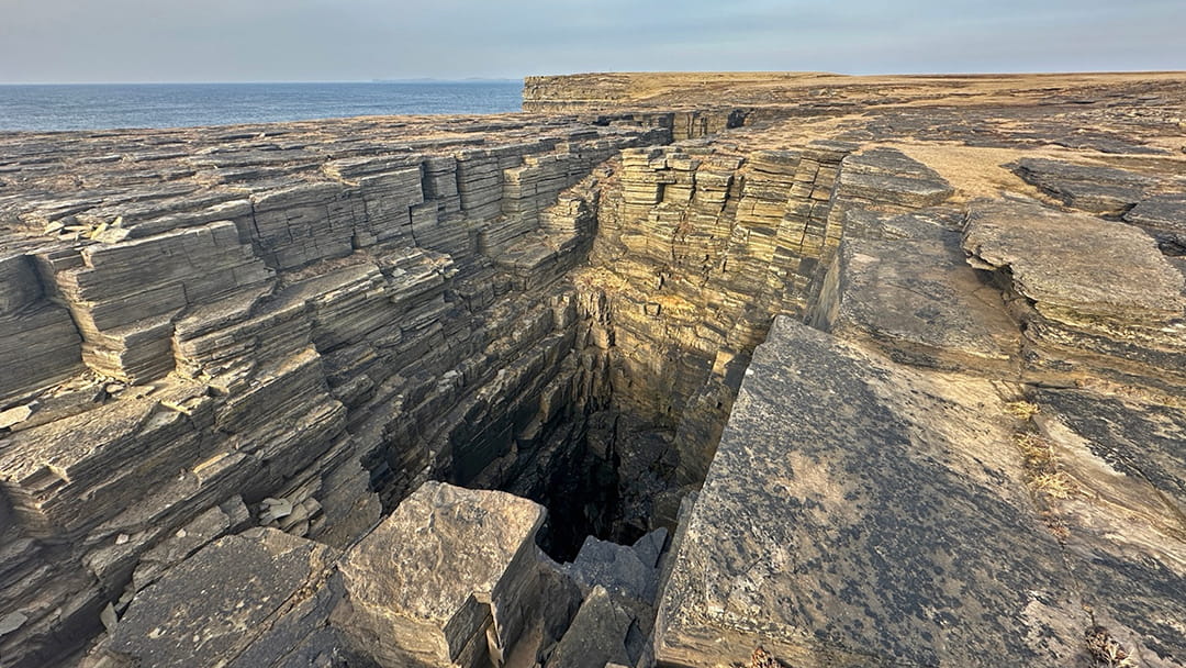 A deep chasm at the Kilns of Brin Novan in Rousay